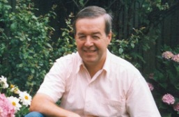 head and shoulders of right time's owner, somewhere in the garden