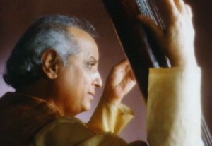 head and shoulder of pandit jasraj, holding tanpura, taken from the right side